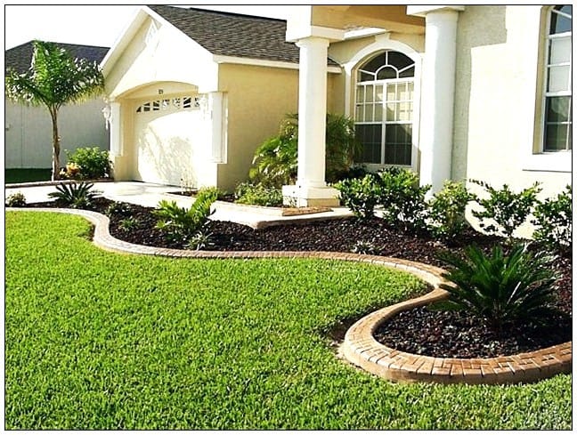 Well-defined garden bed edges with clean lawn border and mulch — lawn edging result