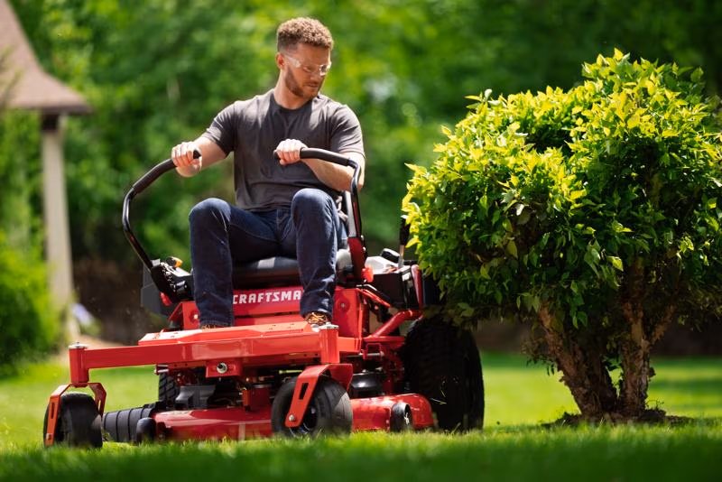 Person on a ride-on lawn mower